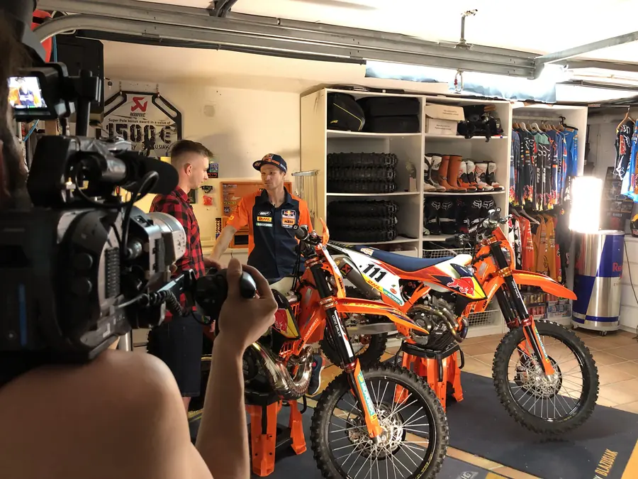 Motocross riders in a workshop