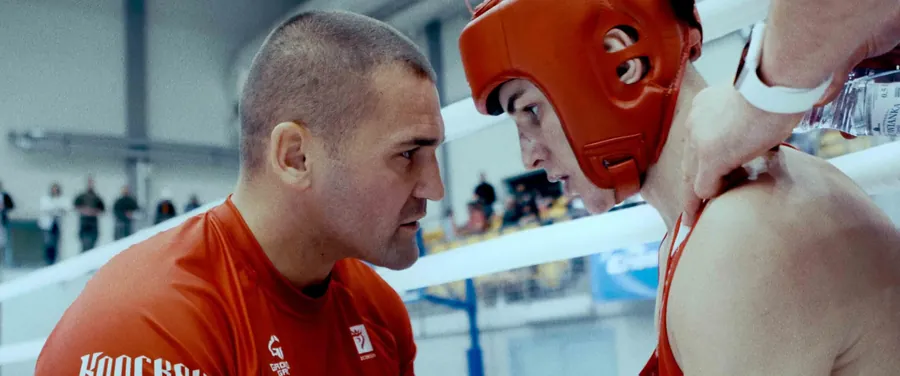 A coach advising the boxer in the corner
