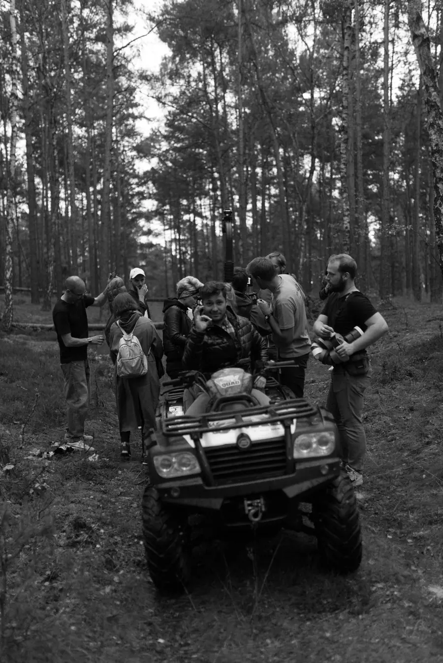 Crew by a quad bike in the forest
