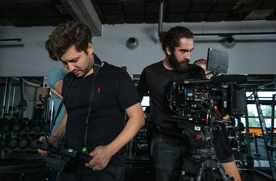 Camera operators on set in a gym