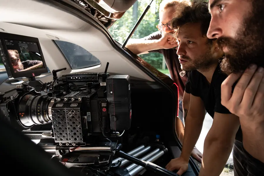 Crew framing a shot in a car boot
