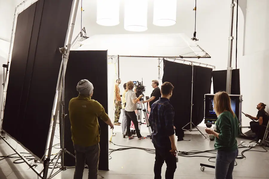 Crew at the monitors in a white studio